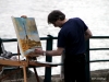 Artist painting Eiffel Tower viewed from Seine River